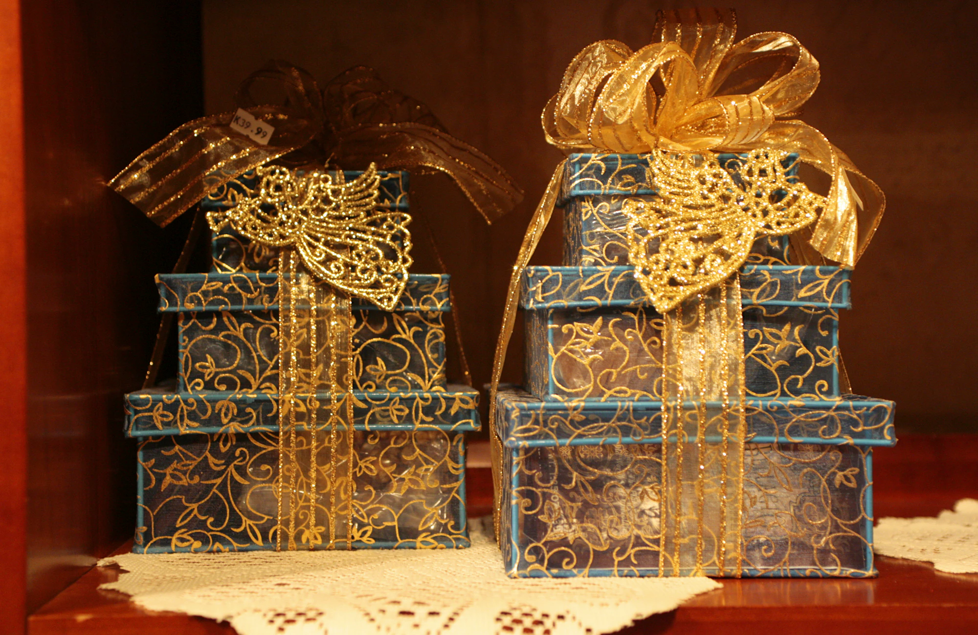 Stacked luxury gift boxes with gold ribbons